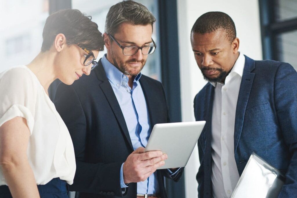 Investidores manuseando plataforma de comunicação de RI digital via tablet.