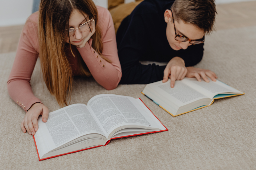 dois adolescentes lendo dicionários