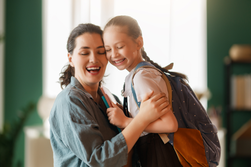 mãe abraçando filha estudante no dia da família