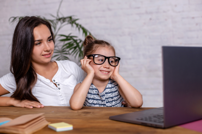 mãe com filha consultando boletim online pelo computador